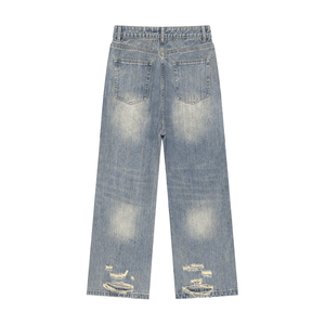 Blue jeans with distressed details on a white background